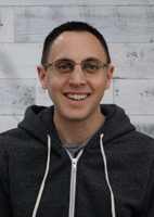 James Baldassari, a software engineer at mabl, has brown hair and is wearing glasses and a grey hoodie.